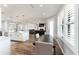 Open-concept dining area with modern lighting and views of the kitchen and living room at 4731 Se 32Nd St, Ocala, FL 34480