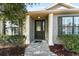 Charming home entrance with a decorative glass front door framed by white pillars and well-maintained landscaping at 4731 Se 32Nd St, Ocala, FL 34480