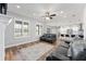 Spacious open-concept living room featuring wood floors, a ceiling fan, and seamless flow into the modern kitchen at 4731 Se 32Nd St, Ocala, FL 34480