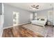 Bright main bedroom features wood-look floors, neutral paint, ensuite bath, and an overhead ceiling fan at 4731 Se 32Nd St, Ocala, FL 34480