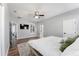 Inviting main bedroom showing floors, a ceiling fan, and an ensuite bath at 4731 Se 32Nd St, Ocala, FL 34480