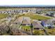 Aerial view of a residential community showcasing well-maintained homes and landscaping and a lake at 5370 Sw 45Th Ave, Ocala, FL 34474