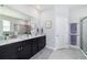 Modern bathroom with dual sinks, granite countertops, and a glass-enclosed shower for a spa-like experience at 5370 Sw 45Th Ave, Ocala, FL 34474