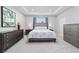 Neutral bedroom featuring modern furniture, patterned bedding, and blue curtains at 5370 Sw 45Th Ave, Ocala, FL 34474