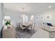 Elegant dining area featuring a wooden table with seating for six, a modern chandelier, and stylish furnishings at 5370 Sw 45Th Ave, Ocala, FL 34474