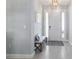 Bright foyer features tile flooring, a white front door with sidelights, and a decorative bench for added convenience at 5370 Sw 45Th Ave, Ocala, FL 34474