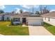 Charming single-story home featuring a well-manicured lawn, a two-car garage, and stone accents for added curb appeal at 5370 Sw 45Th Ave, Ocala, FL 34474