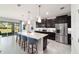 Bright, modern kitchen with a spacious island, stainless steel appliances, and dark cabinets at 5370 Sw 45Th Ave, Ocala, FL 34474