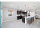 Modern kitchen featuring dark cabinetry, a center island with seating, and stainless steel appliances at 5370 Sw 45Th Ave, Ocala, FL 34474