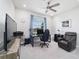 Comfortable office space featuring modern desk setup, a ceiling fan, and a cozy chair at 5370 Sw 45Th Ave, Ocala, FL 34474