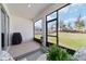 Inviting screened patio featuring a cozy seating area, a grill, and view of the lush backyard space at 5370 Sw 45Th Ave, Ocala, FL 34474