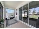 Inviting screened patio featuring a cozy seating area and view of the green backyard space at 5370 Sw 45Th Ave, Ocala, FL 34474