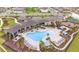 Aerial view of community pool, cabanas, lounge chairs, and manicured landscaping at 5370 Sw 45Th Ave, Ocala, FL 34474