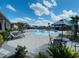 Relaxing pool area with lounge chairs, tables, umbrellas, and well-maintained landscaping at 5370 Sw 45Th Ave, Ocala, FL 34474