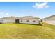 A well-maintained lawn in the backyard complements the home's screened patio and adds outdoor living space at 6213 Sw 97Th St, Ocala, FL 34476