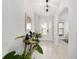 Bright foyer with tiled flooring, decorated console table, and glass-paneled front door at 6213 Sw 97Th St, Ocala, FL 34476