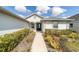 Inviting walkway leads to the front door, surrounded by lush landscaping at 6213 Sw 97Th St, Ocala, FL 34476