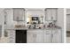 Kitchen featuring granite countertops, gray cabinetry, stainless steel appliances, and a sink with a black faucet at 6213 Sw 97Th St, Ocala, FL 34476