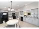 Bright kitchen with gray cabinetry, black appliances, granite countertops, and a cozy breakfast nook with a round dining table at 6213 Sw 97Th St, Ocala, FL 34476