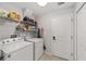 Laundry room includes a washer, dryer, and overhead shelving at 6213 Sw 97Th St, Ocala, FL 34476