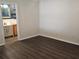 Bedroom showcasing wood-look floors and ensuite bathroom with a decorative blue wall at 6699 Nw 61St St, Ocala, FL 34482