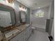 Elegant bathroom featuring granite counters, dual sinks, modern fixtures and tile flooring at 8303 Sw 127 Ave, Dunnellon, FL 34432