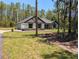 Well-maintained home with lush lawn, stone accents, and a two-car garage at 8303 Sw 127 Ave, Dunnellon, FL 34432