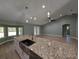 Open-concept kitchen with a large island, granite countertops, and pendant lighting at 8303 Sw 127 Ave, Dunnellon, FL 34432