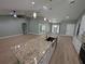 Open-concept kitchen with a large island, granite countertops, and pendant lighting at 8303 Sw 127 Ave, Dunnellon, FL 34432