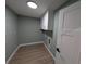Clean laundry room with white cabinets, light paint, and hardwood flooring at 8303 Sw 127 Ave, Dunnellon, FL 34432