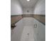 Contemporary shower featuring white tile, decorative accents, and a glass enclosure with gold fixtures at 8303 Sw 127 Ave, Dunnellon, FL 34432