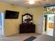 A bedroom featuring a dark wood dresser, ceiling fan, and an adjacent bathroom at 8504 Sw 84Th Loop, Ocala, FL 34481