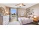 Cozy bedroom featuring a white metal bed frame, decorative art, and a view to the outdoors at 8667 Sw 44Th Ter, Ocala, FL 34476