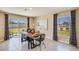 Bright dining area featuring a modern table and chairs, sliding glass doors, and contemporary decor at 8667 Sw 44Th Ter, Ocala, FL 34476