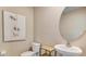 Stylish half bathroom featuring a modern vanity, round mirror, and contemporary wall art at 8667 Sw 44Th Ter, Ocala, FL 34476