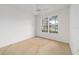 Cozy bedroom featuring neutral carpet, white walls, and bright window at 8669 Sw 88Th Loop, Ocala, FL 34481