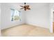 This bright bedroom features a unique ceiling fan and a window dressed with light blue curtains at 8669 Sw 88Th Loop, Ocala, FL 34481