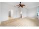 Spacious bedroom showcasing open doorways, neutral carpet, and a decorative ceiling fan at 8669 Sw 88Th Loop, Ocala, FL 34481