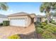 Charming single-story home with a well-manicured lawn, brick driveway, and a two-car garage at 8669 Sw 88Th Loop, Ocala, FL 34481