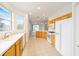 Bright kitchen featuring tiled floor, white appliances, and light wood cabinetry at 8669 Sw 88Th Loop, Ocala, FL 34481