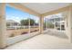 View from the covered and screened lanai showing meticulously landscaped yard and neighboring properties at 8669 Sw 88Th Loop, Ocala, FL 34481