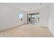 Bright main bedroom featuring carpet, ceiling fan, and sliding glass doors at 8669 Sw 88Th Loop, Ocala, FL 34481