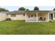 A spacious grassy backyard and covered patio offer outdoor enjoyment at 8677 Sw 95Th Ln # E, Ocala, FL 34481