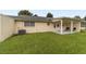 Grassy backyard features a covered patio, offering a perfect outdoor retreat at 8677 Sw 95Th Ln # E, Ocala, FL 34481