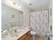 Clean bathroom featuring vanity sink, toilet, and a shower with decorative curtain at 8677 Sw 95Th Ln # E, Ocala, FL 34481