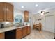 Well-lit kitchen area with tile floors, breakfast table, and stainless dishwasher at 8677 Sw 95Th Ln # E, Ocala, FL 34481