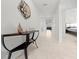 The hallway features tile flooring, neutral walls, console table and view to bedroom at 8920 Sw 49Th Cir, Ocala, FL 34476