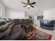 A spacious living room features tile flooring, a ceiling fan, and an open floor plan at 8920 Sw 49Th Cir, Ocala, FL 34476