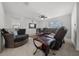 Comfortable living room featuring neutral tile floors, a ceiling fan, and ample seating for relaxing and entertaining at 8920 Sw 49Th Cir, Ocala, FL 34476