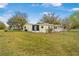 Spacious backyard with a well-maintained lawn, surrounded by a fence, and featuring a screened-in porch for relaxing outdoors at 8973 Sw 104Th Pl, Ocala, FL 34481